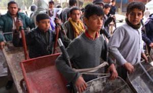 GettyImages-1237092553 Afghan boys carry goods with wheelbarrows to earn a pocket money