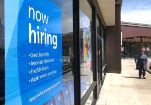 now hiring sign in store window