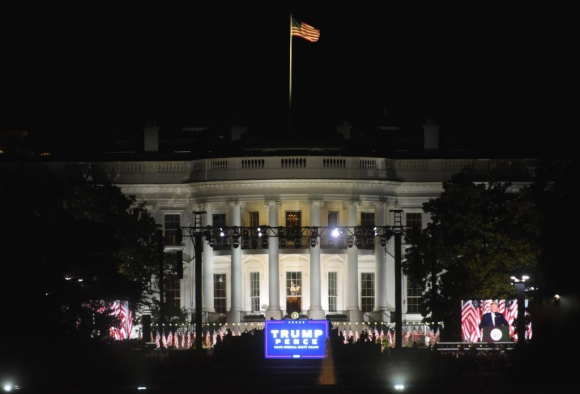 Protests Around White House During Trump's Nomination WASHINGTON, DC - AUGUST 27: U.S. President Donald Trump is seen on a screen while speaking during the Republican National Convention on the South Lawn of the White House on August 27, 2020 in Washington, DC. (Photo by Chen Mengtong/China News Service via Getty Images)